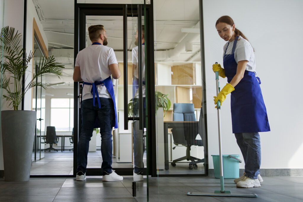 Professional cleaner deep cleaning a modern kitchen during end of tenancy cleaning in Manchester
